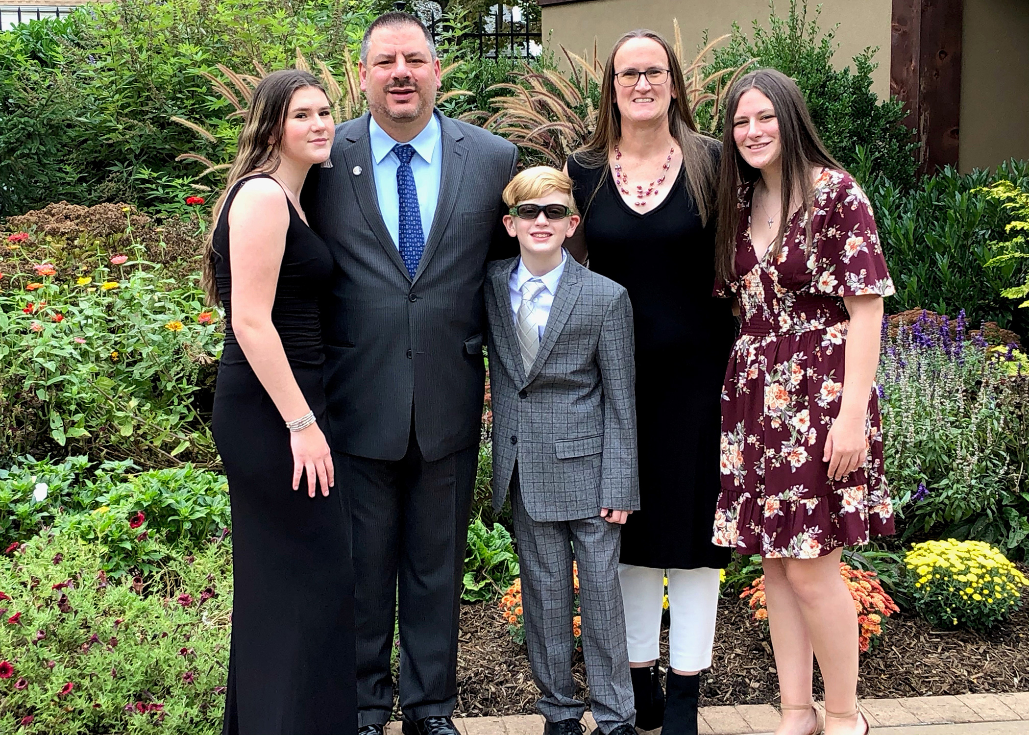 Len Skoros with his family – daughter Brianne (left), son Kellen (center), wife Amanda (second from right) and daughter Ryan (right).